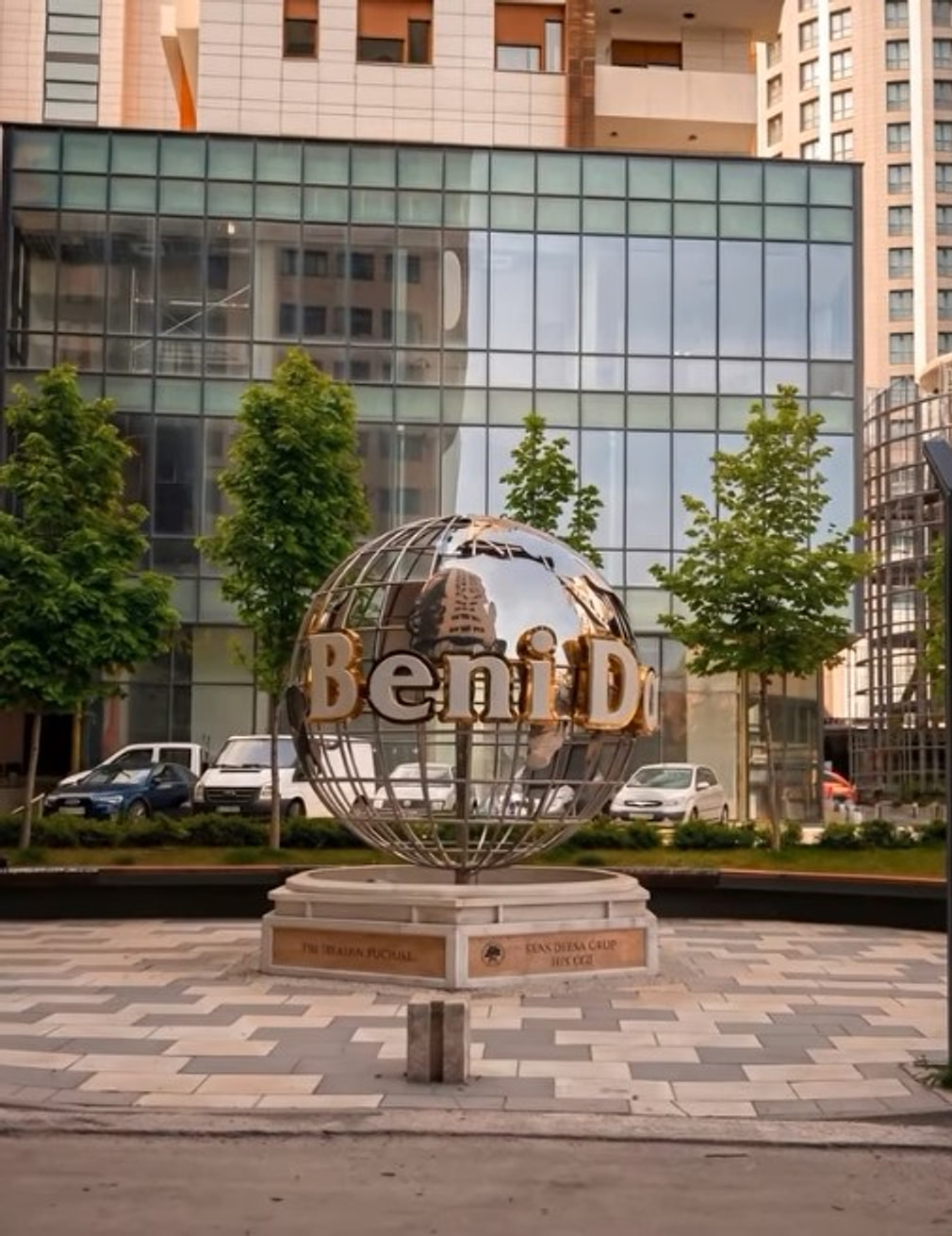 The Beni Dona globe sculpture on the plaza at the entrance to the complex